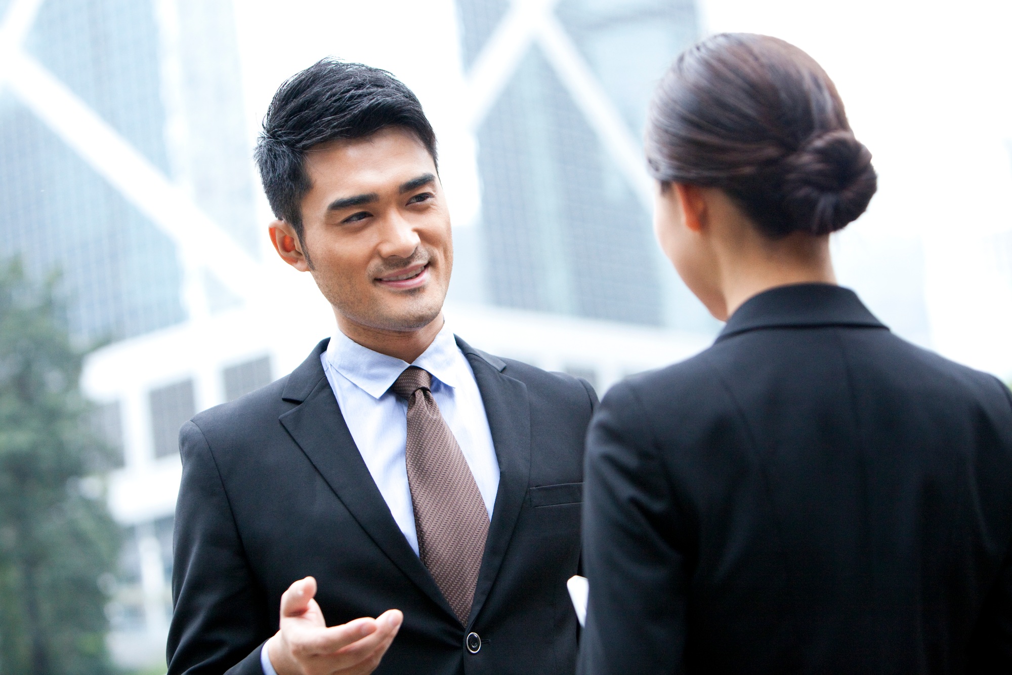 Cheerful business partners talking face to face, Hong Kong